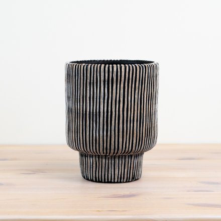 Elegant planter in black with lined pattern adds a touch of sophistication to any space.