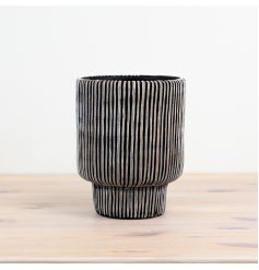 Elegant planter in black with lined pattern adds a touch of sophistication to any space.