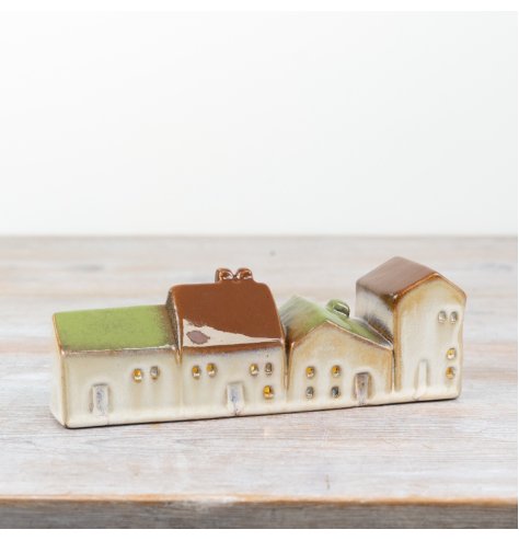 Light up your space with our delightful ceramic house, featuring a built-in LED light. 