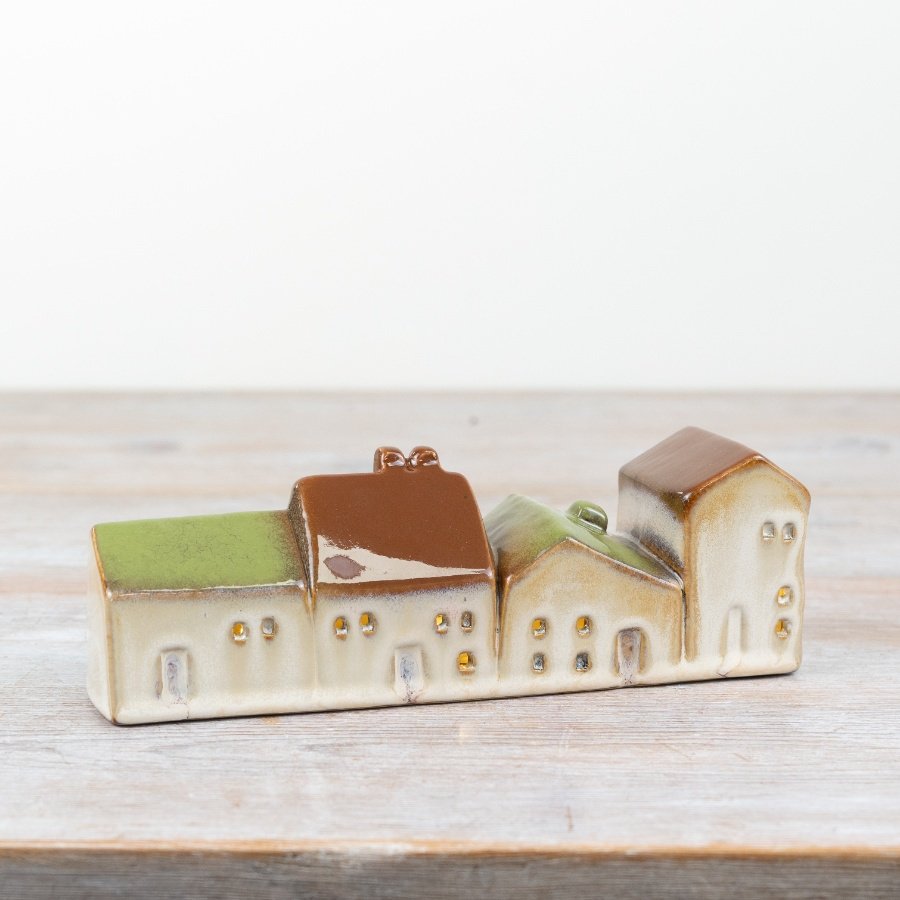 Brighten your space with our lovely ceramic house, featuring a built-in LED light.