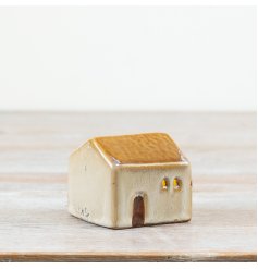 Add a charming glow to your home with this delightful ceramic house.