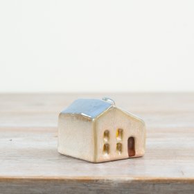This 5cm ceramic house with a soft blue roof has cut-out windows that softly glow from the LED inside.