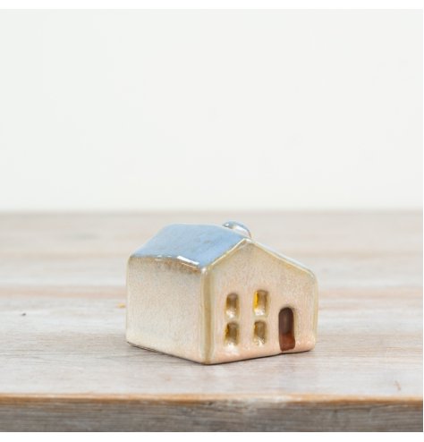 This 5cm ceramic house has a gentle blue roof and cut-out windows for a cozy LED glow.