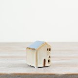 7cm ceramic house with a blue roof and charming cut-out windows.