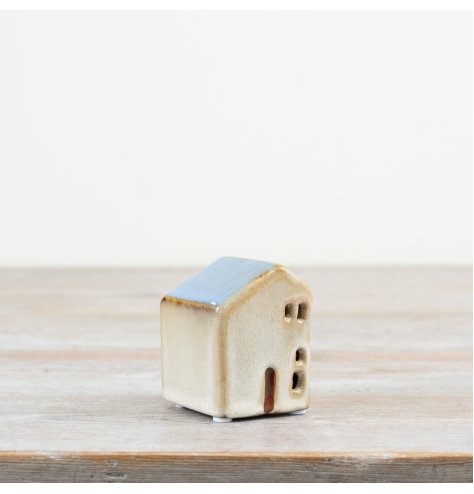 7cm ceramic house with a blue roof and charming cut-out windows.