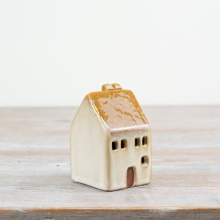 Brighten your decor with this 8cm LED ceramic house, adding a warm rustic charm to any space.