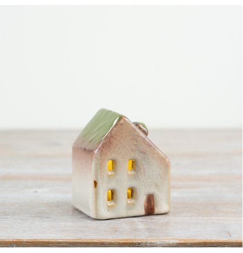 Add cozy charm with this 8cm LED ceramic house featuring a green roof for warm, inviting light.