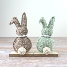 Elevate your Easter display with these soft green and warm brown sherpa bunnies.