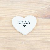 A simple but meaningful heart token in white made from ceramic.