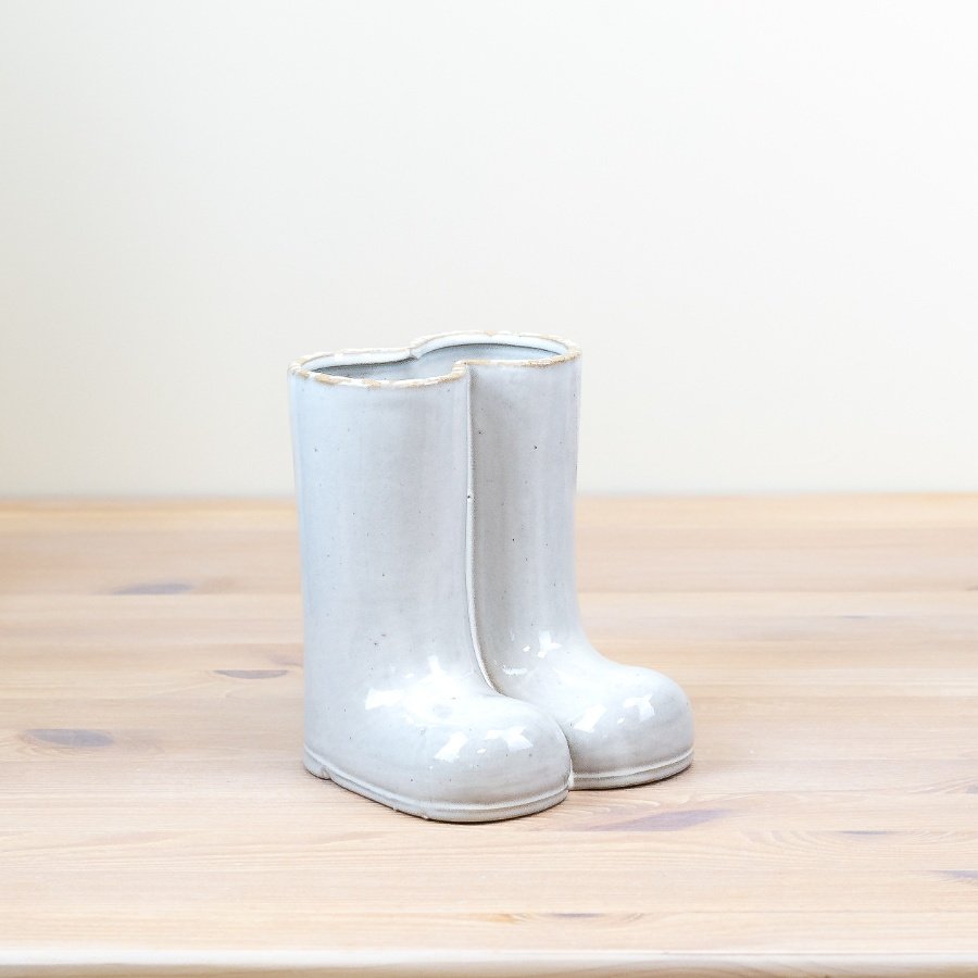 Add a unique touch to your home with our glazed vase featuring a charming wellington boot design.