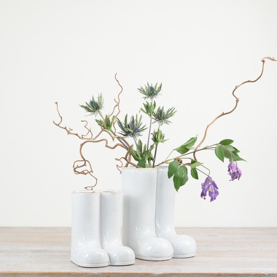 Add a unique touch to your home with our glazed vase featuring a charming wellington boot design.