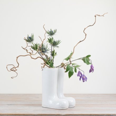 Elegant porcelain vase in the shape of boots, perfect for adding a touch of whimsy to any room.
