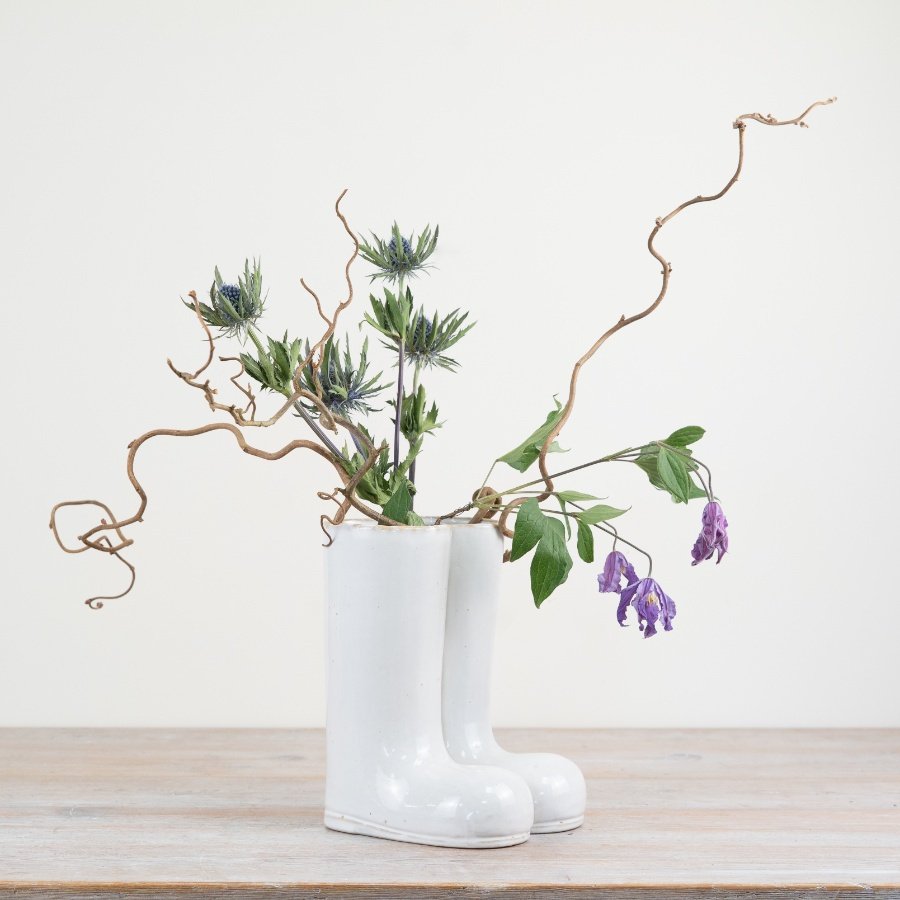Elegant porcelain vase designed as stylish boots adds charm to any home decor.