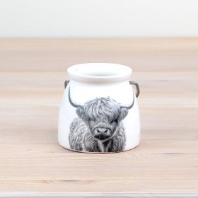 Add charm to your space with a cream lantern featuring an adorable Highland Cow pattern. 