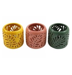 An assortment of 3 coloured tea light holders each with a cut out leaf pattern.