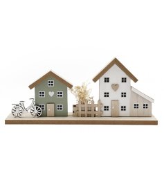 This charming wooden house scene brings a pop of Spring colours to your windowsill or shelf