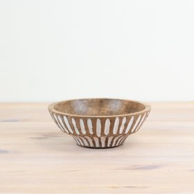 Bring rustic charm to your table with a patterned serving bowl.