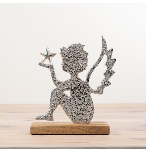 A chic angel ornament sat upon a rustic wooden base. Made from hammered aluminium with a star detail. 