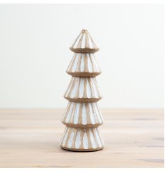 A rustic wooden tree with carved detailing and a white washed finish. 