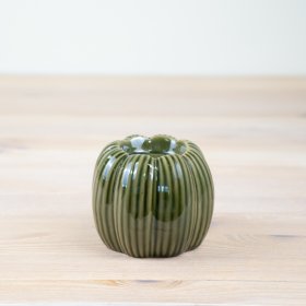 Bring a touch of seasonal charm to your home with our elegant porcelain pumpkin candle holder.