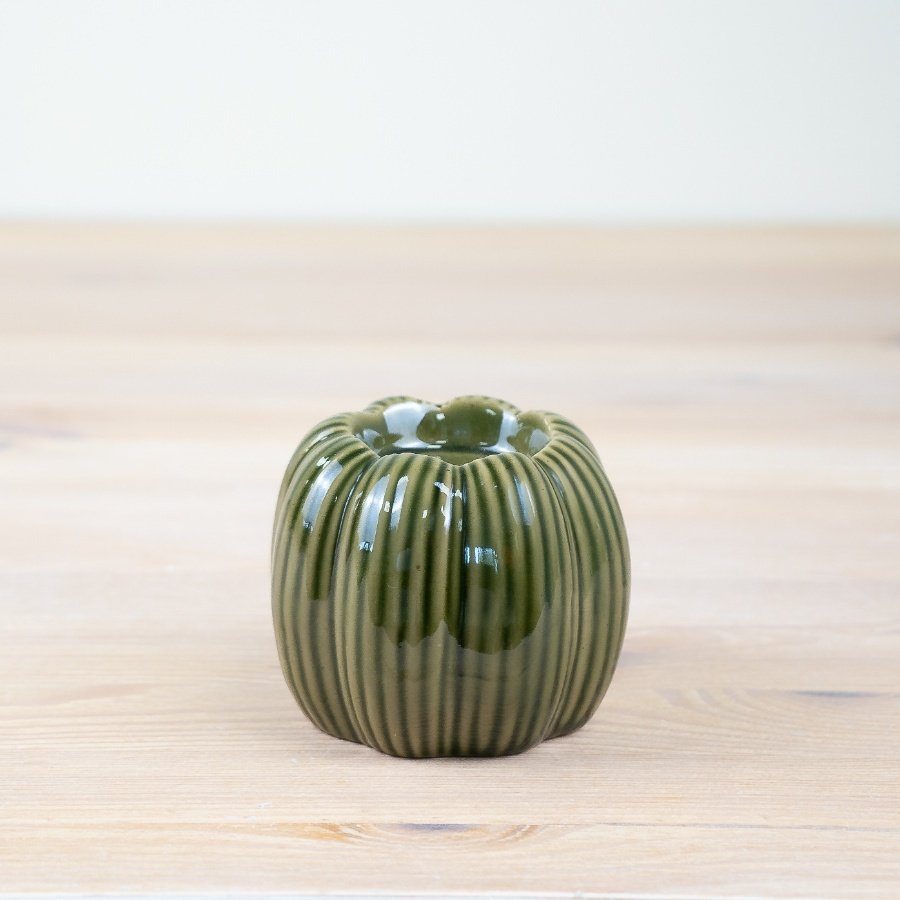 Bring a touch of seasonal charm to your home with our elegant porcelain pumpkin candle holder.