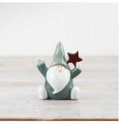 Deck the halls with our delightful "Green Santa Holding Star" figurine. Spread joy and merriment this season!