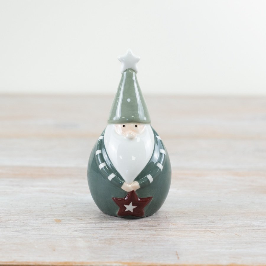 Decorate your home with the delightful "Green Santa Holding Star" for a festive touch.