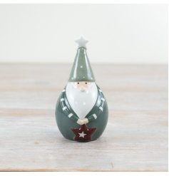 Spice up your holiday decor with the delightful "Green Santa with Star" figurine.