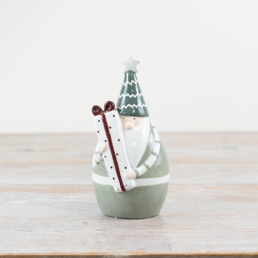 Celebrate the holiday season with our whimsical 'Green Santa Holding Present' ornament. 