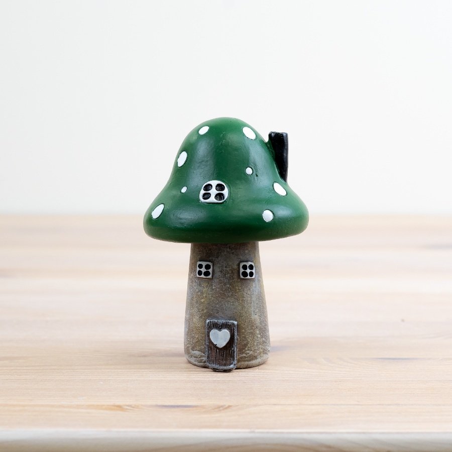 Introduce a touch of enchantment to any living space with this charming green mushroom house.