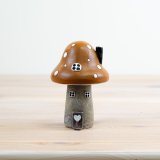 Add a touch of whimsy to your home or garden with our charming Mushroom House Ornament 