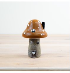 Add a touch of whimsy to your home or garden with our charming Mushroom House Ornament 