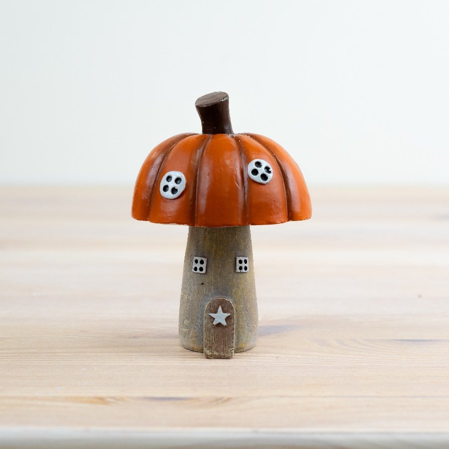 Bring autumn charm to your home with the delightful Pumpkin Roof House Ornament. 