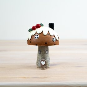 Enhance the festive decor with our charming Pudding Roof House Ornament 
