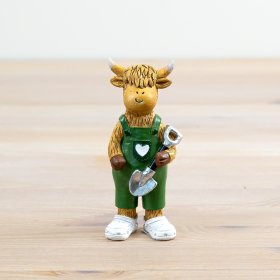 Discover our charming cow figurine, proudly holding a garden shovel, perfect for adding character to any space.