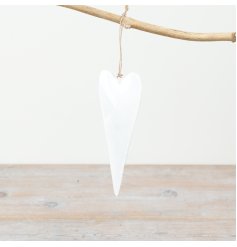 Effortlessly chic, this white iron heart on twine adds a touch of whimsy to any space.