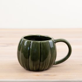 Green pumpkin mug with stylish design, perfect for any hot beverage.