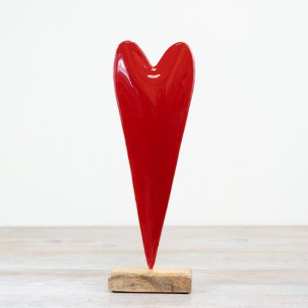 A stylish heart shaped ornament with a glossy finish. Set upon a chunky mango wood base.