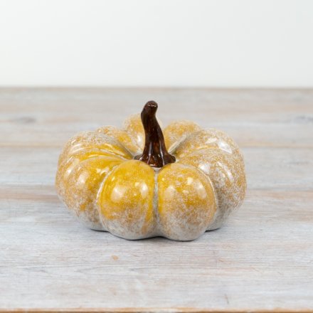 A pumpkin ornament complete with a natural orange and grey glaze