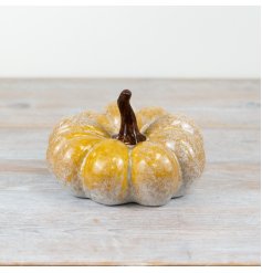 A pumpkin ornament complete with a natural orange and grey glaze