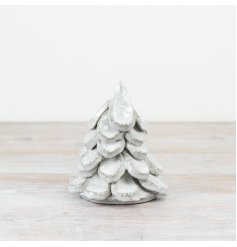A stunning ceramic Christmas tree with a glossy white glaze and distressed edges. 