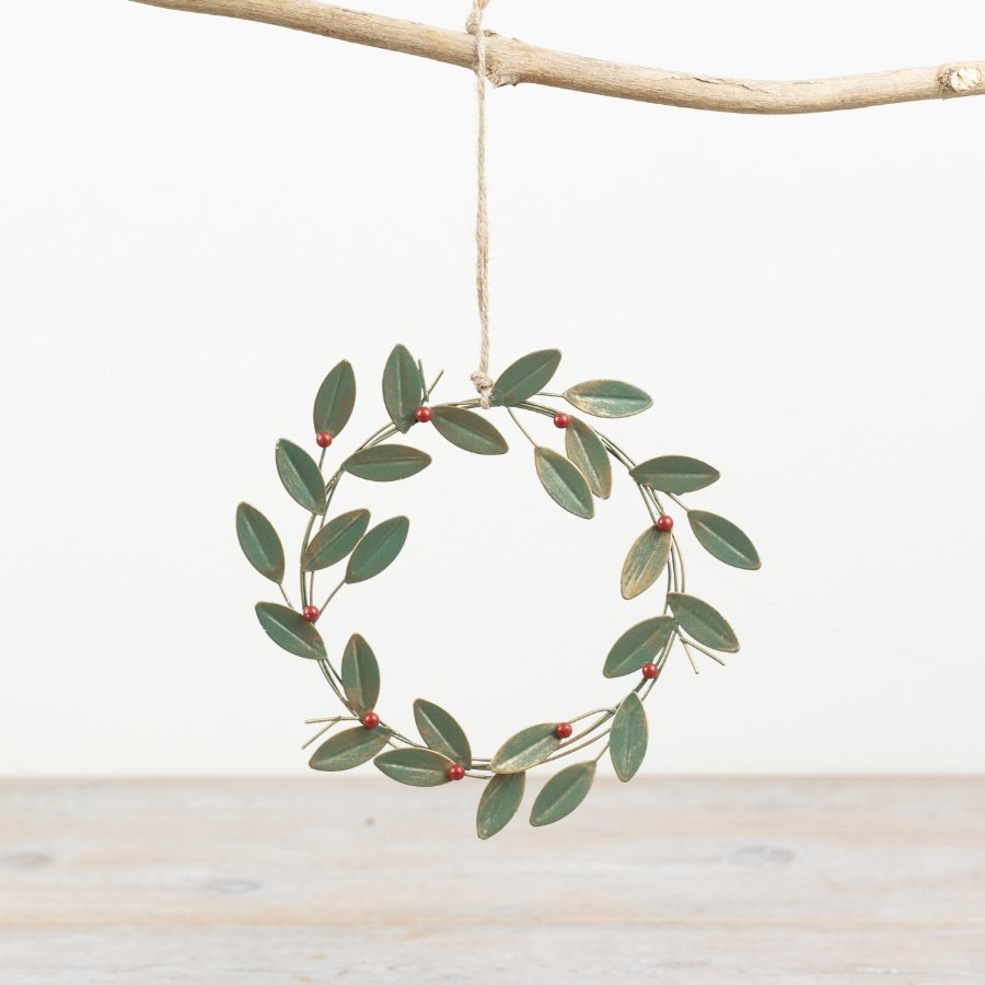 A vintage inspired metal wreath with red berries and gold detailed leaves. Complete with a jute string hanger.