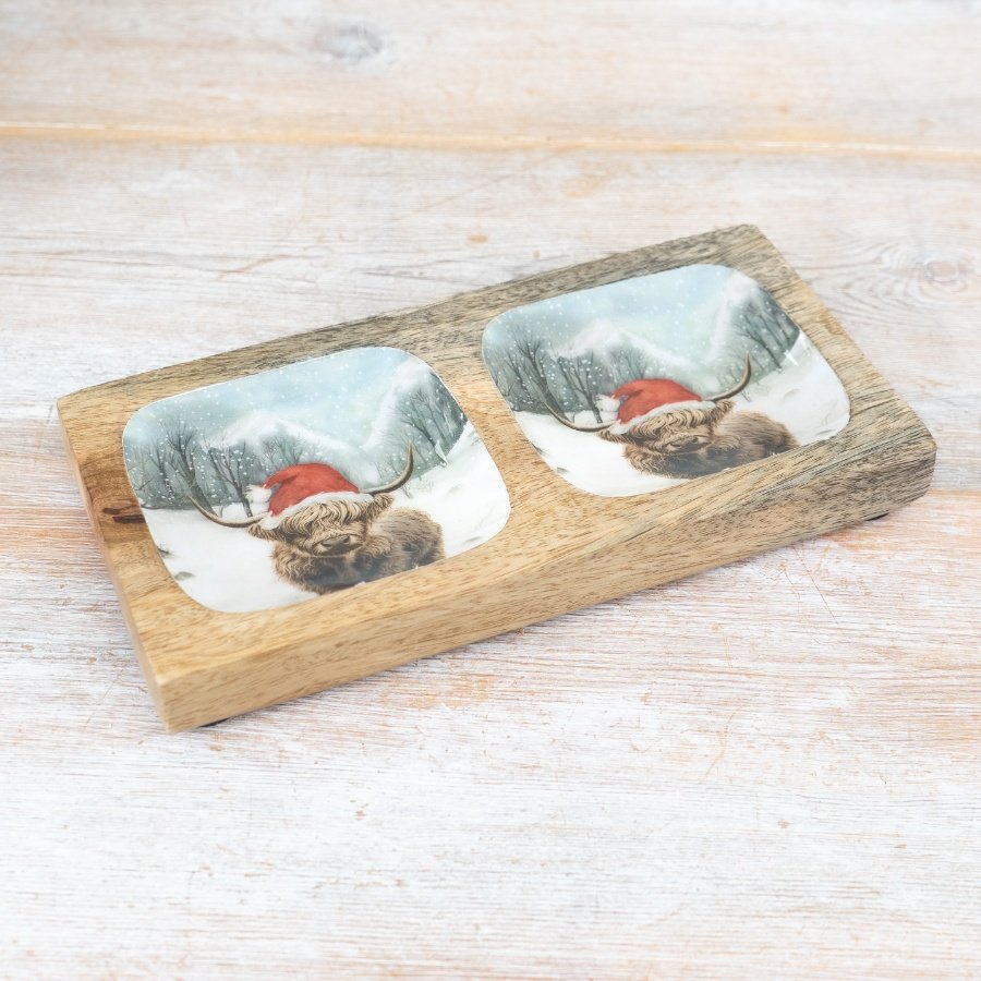 Enjoy seasonal snacks with this rustic two part mango wood tray. Featuring a colourful Winter Highland Cow design. 