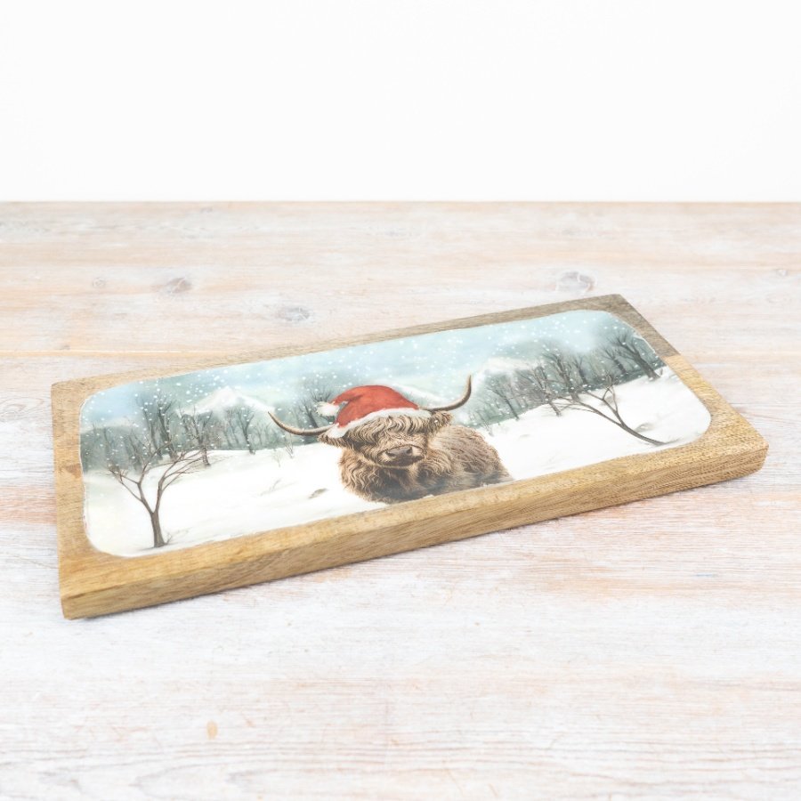 Make a statement this season with this artisan mango wood tray. Beautifully adorned with a colourful highland cow design