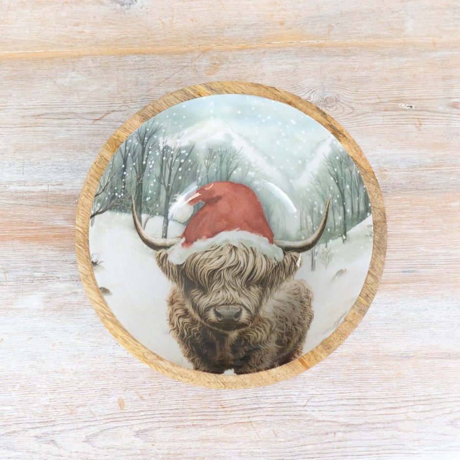 A rustic, artisan bowl made from mango wood. Complete with an enamel centre depicting a winter scene with Highland Cow. 