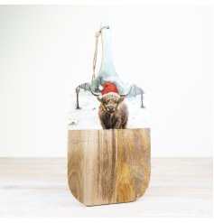 A beautifully illustrated Christmas highland cow design set in enamel on a rustic mango wood board.