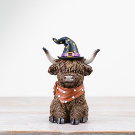 A spooky resin highland cow ornament complete with a witches hat and scarf. Great for adding some spooky country charm.