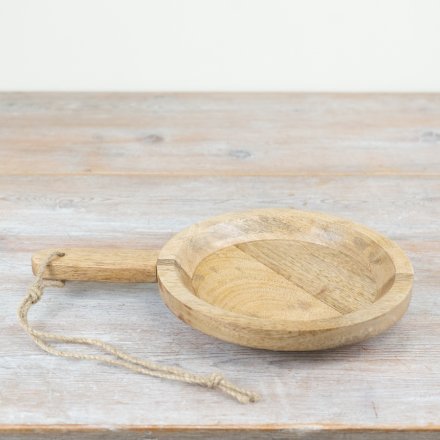 A gorgeous rustic serving board made from wood with a thick handle and jute hanger. 