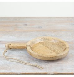 A gorgeous rustic serving board made from wood with a thick handle and jute hanger. 