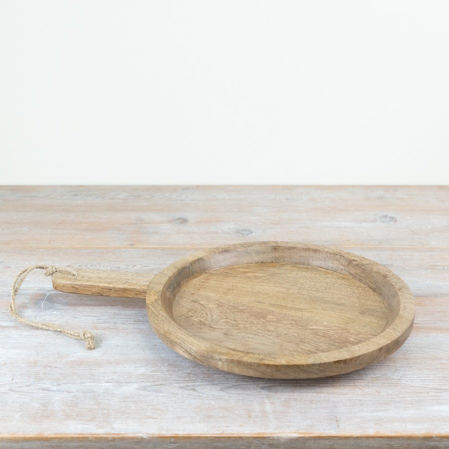 Stylish round board for serving and chopping, made of beautiful wood. 